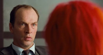Movie still from “Run Lola Run” (1998), directed by Tom Tykwer – A man in a suit and tie looking at another man in a suit and tie; Close Up shot, Over the shoulder angle
