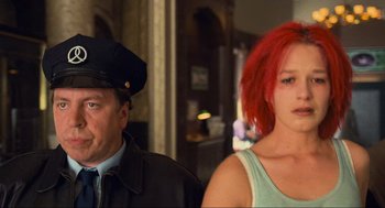 Movie still from “Run Lola Run” (1998), directed by Tom Tykwer – A man and a woman standing next to each other; Close Up shot, Low angle