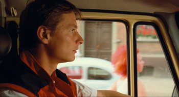Movie still from “Run Lola Run” (1998), directed by Tom Tykwer – A man sitting in the passenger seat of a bus; Close Up shot, Over the shoulder angle
