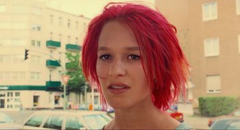 Movie still from “Run Lola Run” (1998), directed by Tom Tykwer – A person with red hair; Close Up shot, Low angle