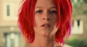 Movie still from “Run Lola Run” (1998), directed by Tom Tykwer – A person with red hair; Close Up shot, Low angle