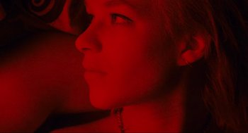 Movie still from “Run Lola Run” (1998), directed by Tom Tykwer – A woman with a red light in the background; Extreme Close Up shot, Overhead angle