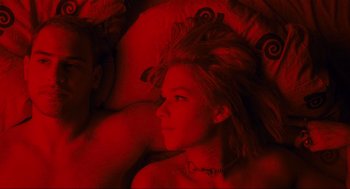 Movie still from “Run Lola Run” (1998), directed by Tom Tykwer – A woman laying in a bed with a man; Medium shot, Overhead angle