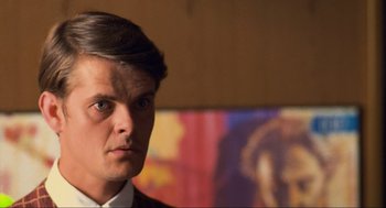 Movie still from “Run Lola Run” (1998), directed by Tom Tykwer – A person wearing a suit and tie; Close Up shot, Low angle