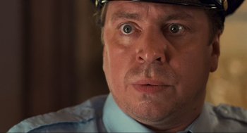 Movie still from “Run Lola Run” (1998), directed by Tom Tykwer – A person wearing a police uniform; Close Up shot, Low angle