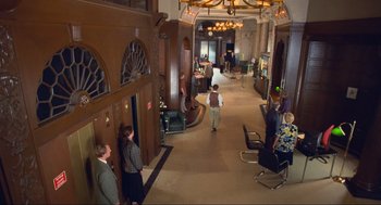 Movie still from “Run Lola Run” (1998), directed by Tom Tykwer – A group of people standing in a room; Wide shot, High angle