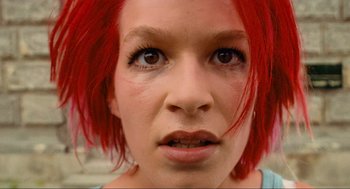 Movie still from “Run Lola Run” (1998), directed by Tom Tykwer – A person with red hair; Close Up shot, Low angle