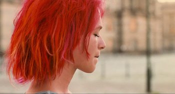 Movie still from “Run Lola Run” (1998), directed by Tom Tykwer – A woman with red hair looking to the side; Close Up shot, Over the shoulder angle