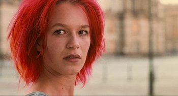 Movie still from “Run Lola Run” (1998), directed by Tom Tykwer – A person with red hair; Close Up shot, Low angle