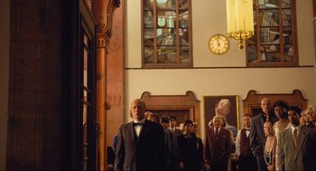 Movie still from “Run Lola Run” (1998), directed by Tom Tykwer – A group of people standing in front of a window; Wide shot, Low angle