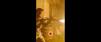 Movie still from “SAS: Red Notice” (2021), directed by Magnus Martens – A man holding a gun and aiming it at a building; Extreme Close Up shot, High angle