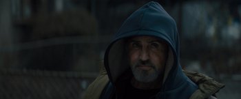 Movie still from “Samaritan” (2022), directed by Julius Avery – A person wearing a hooded jacket; Close Up shot, Low angle