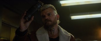 Movie still from “Samaritan” (2022), directed by Julius Avery – A man with a white beard and a white jacket is combing his hair; Close Up shot, Low angle