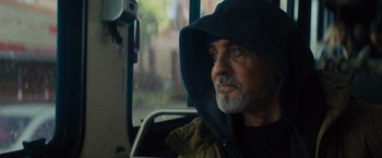 Movie still from “Samaritan” (2022), directed by Julius Avery – A man with a beard wearing a hooded jacket; Close Up shot, Low angle
