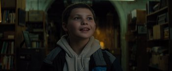 Movie still from “Samaritan” (2022), directed by Julius Avery – A young boy is looking up at the sky; Close Up shot, Low angle