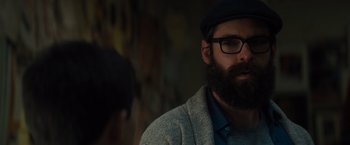 Movie still from “Samaritan” (2022), directed by Julius Avery – A man with a beard wearing glasses and a hat; Close Up shot, Over the shoulder angle
