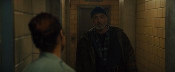 Movie still from “Samaritan” (2022), directed by Julius Avery – An older man is looking into the mirror; Medium shot, Over the shoulder angle