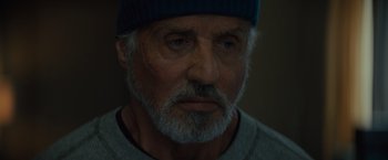 Movie still from “Samaritan” (2022), directed by Julius Avery – An old man with a beard and a blue hat; Close Up shot, Over the shoulder angle