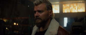 Movie still from “Samaritan” (2022), directed by Julius Avery – A person with a tattoo on his face; Close Up shot, Over the shoulder angle