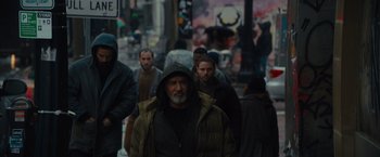 Movie still from “Samaritan” (2022), directed by Julius Avery – A group of people walking down a street; Wide shot, Low angle