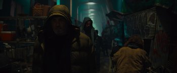 Movie still from “Samaritan” (2022), directed by Julius Avery – A group of people walking down a dark hallway at night; Medium shot, Low angle