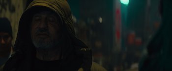Movie still from “Samaritan” (2022), directed by Julius Avery – A man wearing a hooded jacket in the dark; Close Up shot, Low angle