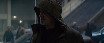 Movie still from “Samaritan” (2022), directed by Julius Avery – A person wearing a hooded jacket; Close Up shot, Low angle