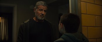 Movie still from “Samaritan” (2022), directed by Julius Avery – An older man looking in the mirror while a younger man looks at him; Close Up shot, Over the shoulder angle