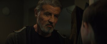 Movie still from “Samaritan” (2022), directed by Julius Avery – An older man with a gray beard looking into a mirror; Close Up shot, Low angle