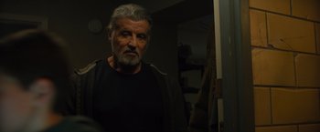 Movie still from “Samaritan” (2022), directed by Julius Avery – An older man standing in front of a mirror; Close Up shot, Over the shoulder angle