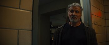 Movie still from “Samaritan” (2022), directed by Julius Avery – An older man standing in front of a mirror; Close Up shot, Low angle