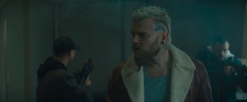 Movie still from “Samaritan” (2022), directed by Julius Avery – A man with tattoos on his head and a beard; Close Up shot, Over the shoulder angle