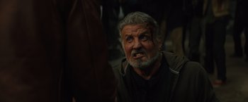 Movie still from “Samaritan” (2022), directed by Julius Avery – An old man with a scar on his face; Close Up shot, Low angle