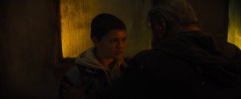 Movie still from “Samaritan” (2022), directed by Julius Avery – A young boy is looking at a man in a dark room; Close Up shot, Over the shoulder angle