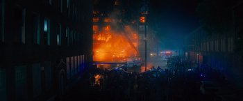 Movie still from “Samaritan” (2022), directed by Julius Avery – A large fire burning in the middle of the night; Extreme Wide shot, High angle