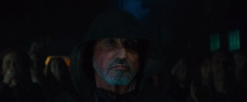 Movie still from “Samaritan” (2022), directed by Julius Avery – A person wearing a hooded jacket; Close Up shot, Over the shoulder angle