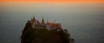 Movie still from “Samsara” (2011), directed by Ron Fricke – A view of a large building with a lot of spires on top of it; Extreme Wide shot, Low angle