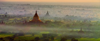 Movie still from “Samsara” (2011), directed by Ron Fricke – A view of a valley with many trees in the background; Extreme Wide shot, High angle