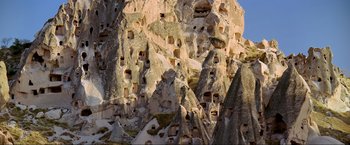 Movie still from “Samsara” (2011), directed by Ron Fricke – A rock formation that has many holes in it; Extreme Wide shot, Low angle