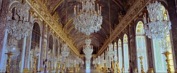 Movie still from “Samsara” (2011), directed by Ron Fricke – A room filled with chandeliers and gold statues; Extreme Wide shot, Low angle