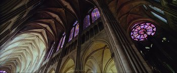 Movie still from “Samsara” (2011), directed by Ron Fricke – A large cathedral with stained - glass windows and arches; Extreme Wide shot, Low angle