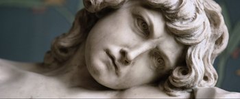 Movie still from “Samsara” (2011), directed by Ron Fricke – The face of a marble statue; Extreme Close Up shot, High angle