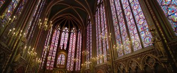 Movie still from “Samsara” (2011), directed by Ron Fricke – A large cathedral with stained - glass windows and chandeliers; Extreme Wide shot, High angle