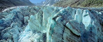 Movie still from “Samsara” (2011), directed by Ron Fricke – View of a rock formation in the mountains; Extreme Wide shot, High angle