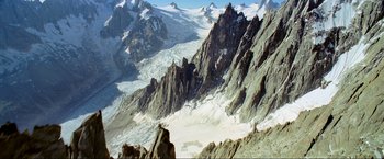 Movie still from “Samsara” (2011), directed by Ron Fricke – A view of a mountain range with snow on it's slopes; Extreme Wide shot, High angle