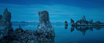 Movie still from “Samsara” (2011), directed by Ron Fricke – A body of water that has some rocks in the water; Extreme Wide shot, Low angle