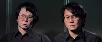 Movie still from “Samsara” (2011), directed by Ron Fricke – A man in a black shirt and a man in a black shirt; Close Up shot, Low angle
