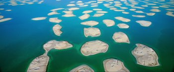 Movie still from “Samsara” (2011), directed by Ron Fricke – An aerial view of a large body of water; Extreme Wide shot, Overhead angle