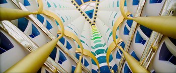 Movie still from “Samsara” (2011), directed by Ron Fricke – A view of a spiral stair case from the ground up; Extreme Wide shot, Overhead angle