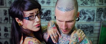 Movie still from “Samsara” (2011), directed by Ron Fricke – A man and a woman are looking at each other; Close Up shot, Overhead angle